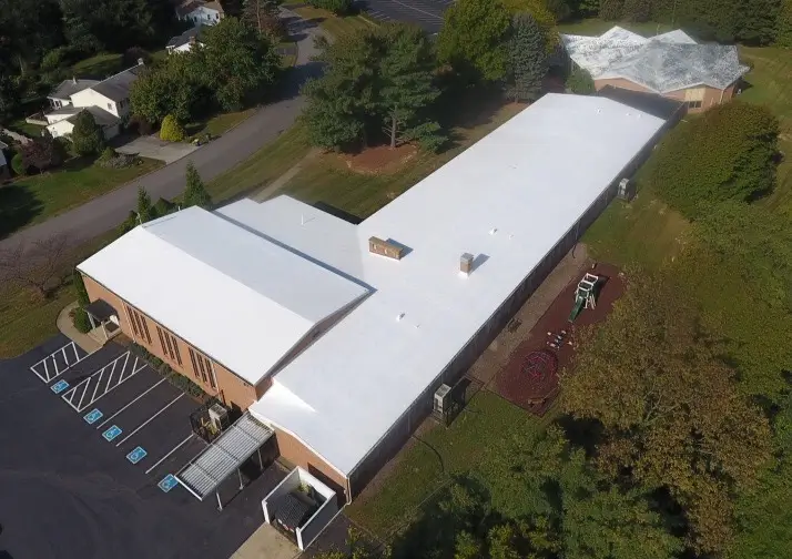 An aerial view of a commercial rooftop with roof replacement in Lancaster County