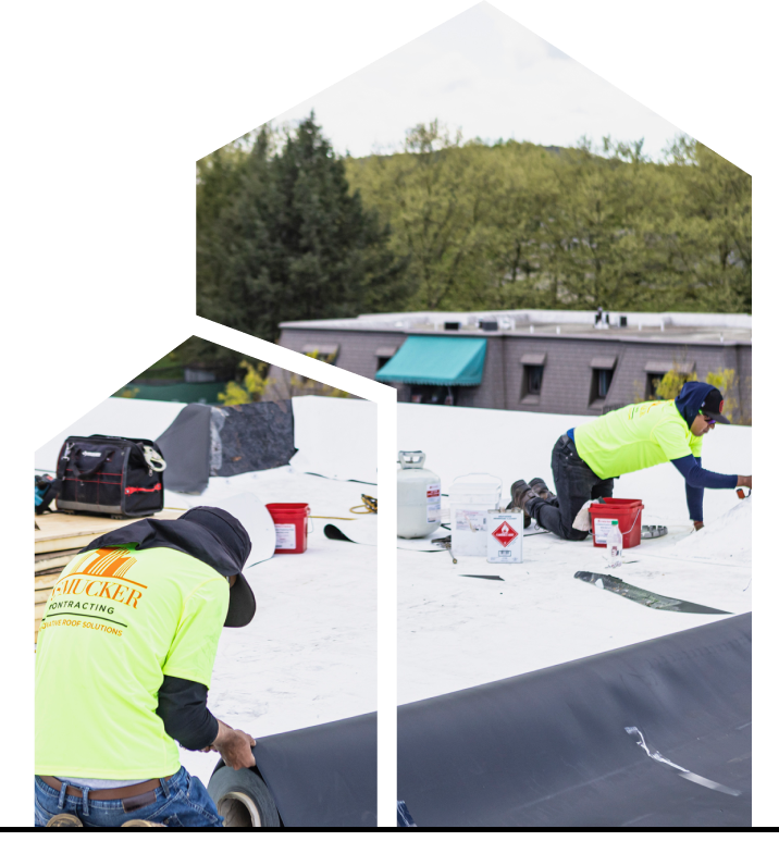 Two team members from J. Smucker Contracting on the roof for a commercial roof replacement